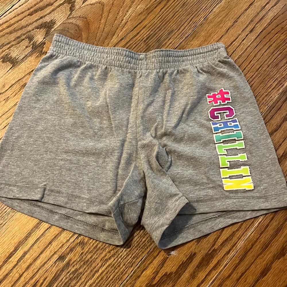 Grey shorts with wording on side
